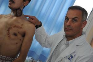 Dr. Eyal Sela points to wound on one of the patients from Syria being treated at Western Galilee Medical Center in Nahariya, Israel. 