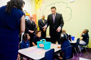 Washington, D.C., Mayor Vincent Gray visits a kindergarten class as school executive director Jason Lody watches.