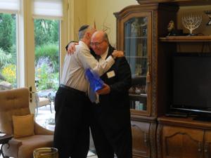 Jody Harburger, right, embraces Michael Hoffman after seven years of working together. 