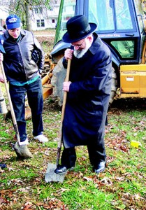 Rabbi Gedaliah Anemer breaks ground in 2002 for the  expansion of the Arcola Avenue Boys Division campus as Denny Berman looks on.