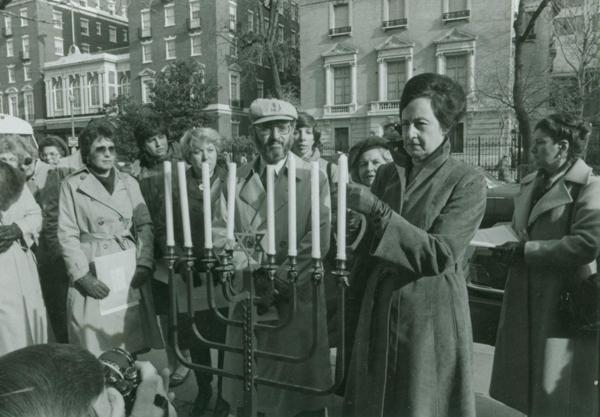 At the annual Women’s Plea for Human Rights for Soviet Jews in 1982, Joan Dodek, Washington Committee for Soviet Jewry president, lights a Chanukah menorah with Nathan Lewin (center), former Jewish Community Council of Greater Washington president. JHSGW Collections