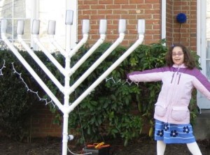 Rachel Robin stands by her family’s menorah in 2008. The menorah was vandalized days after her bat mitzvah in December. Photo by Ellen Robin