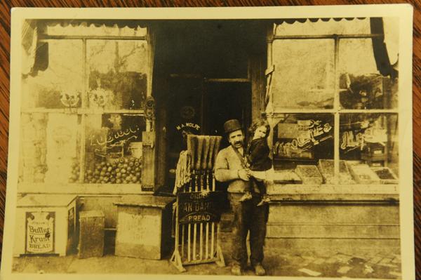 In a 1913 photo, Myra Sklarew's grandfather holds her mother in front of the family's general store in D.C. Photo by Lloyd Wolf
