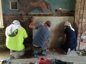Following a week of conservation, the original portions of the synagogue mural were removed from the wall and placed into storage crates.  Photo courtesy of The Jewish Historical Society