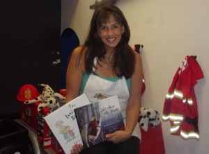 Gina Seebachan poses with two books in the Playseum. Photo by Julian Sadur 