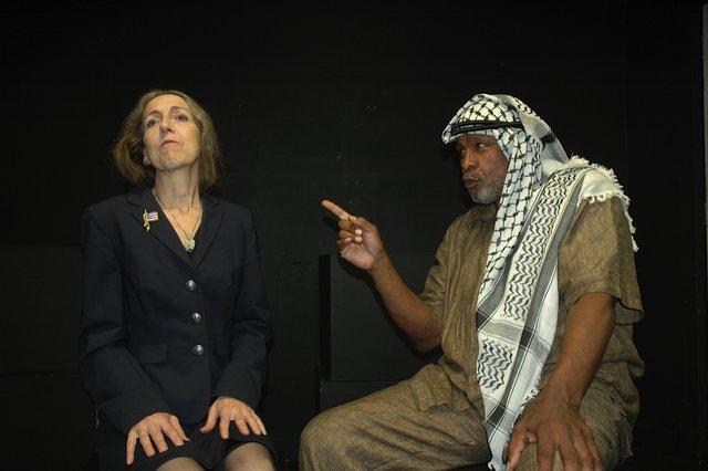 Mary Jane Oelke as Madeleine Albright and Percy W. Thomas as Yasser Arafat deliver a heated exchange in Fourteen Days in July, a dramatization of tense negotiations during the Camp David Israeli-Palestinian peace talks in 2000, based on the memoir of Ambassador Dennis Ross, "The Missing Peace." Photo by Marc Apter 
