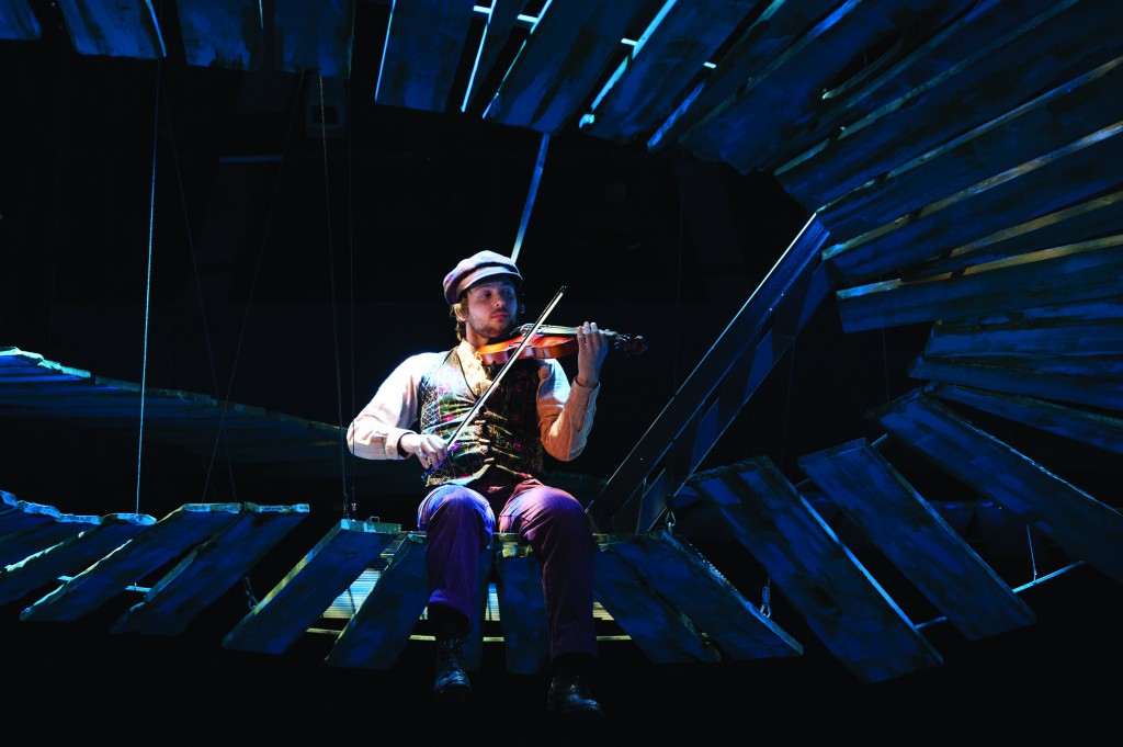 Alex Alferov as the Fiddler in 'Fiddler on the Roof' at Arena Stage. Photo by Margot Schulman