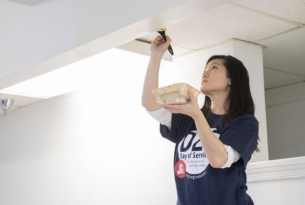 Alexis Matsui, 31, paints the ceiling of a men’s dining area at the Community for Creative Non-Violence, the largest homeless shelter in metro D.C., as part of the DCJCC’s MLK Day of Service on January 19. 