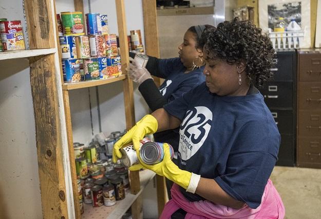 Melissa Lewis (left) and Gio Jones sort through canned food at the Community for Creative Non-Violence, the largest homeless shelter in metro D.C., as part of the DCJCC’s MLK Day of Service on January 19. 