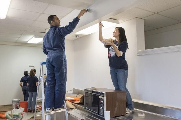 Rodeece Dean, 35, and Alexis Matsui, 31, paint the ceiling of a men’s dining area at the Community for Creative Non-Violence, the largest homeless shelter in metro D.C., as part of the DCJCC’s MLK Day of Service on January 19. 