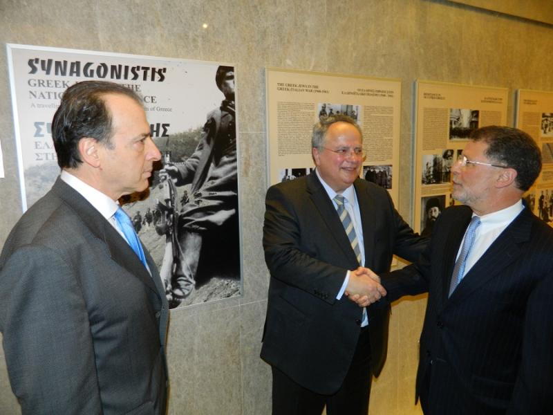 Washington Hebrew Congregation Senior Rabbi Bruce Lustig, right, shakes hands with Greek Foreign Minister Nikos Kotzias as Ambassador of Greece to the United States Christos Panagopoulos looks on during a reception for the traveling exhibition on the Greek Jewish resistance movement in World War II.Photo by Josh Marks