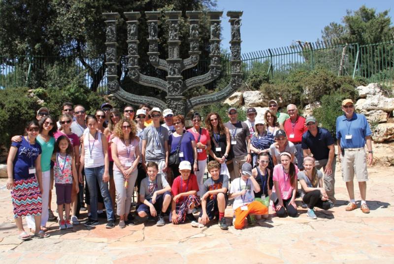 As part of the tour, families gather at the giant menorah by the Knesset in Jerusalem, where b’nai mitzvah certificates are handed out. Photo courtesy of Israel Discovery Tours
