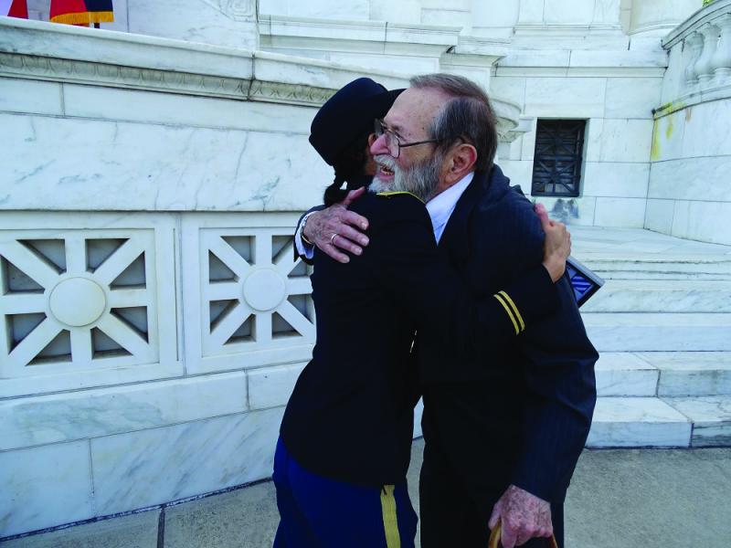 3rd Infantry Division veteran William  Weinberg hugs U.S. Army retired Capt. C. Monika Stoy at the 70th anniversary of the liberation of Salzburg and Austria at Arlington National Cemetery on May 28.