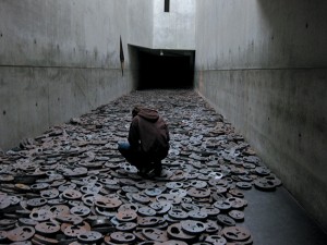 In Israeli artist Menashe Kadishman’s installation “Fallen Leaves,” at the Jewish Museum in Berlin, a river of cast-iron faces disappears into the void. Courtesy of Flickr