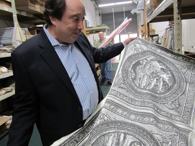 Donald Hurwitz of Carlton House Fabrics shows off a panel of cloth depicting the biblical story of Jacob’s ladder.Photo by Emilie Plesset
