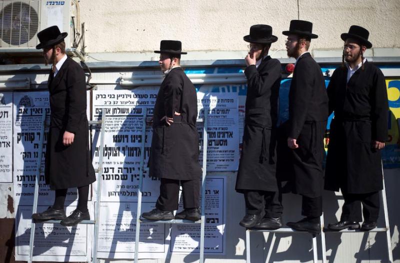 Ultra-Orthodox Jews watch the funeral procession of prominent Jewish Rabbi Eliezer Hager in Haifa, Israel, on July 8. JTA