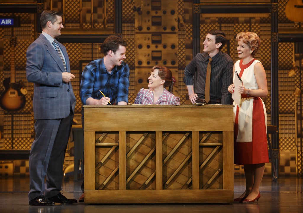 At the piano in the show Beautiful, from left, are Curt Bouril as producer Don Kirshner, Liam Tobin as Carole King’s writing partner and husband Gerry Goffin, Abby Mueller as Carole King, Ben Fankhauser as songwriter Barry Mann and Becky Gulsvig as his songwriting partner Cynthia Weil.Photo by Joan Marcus