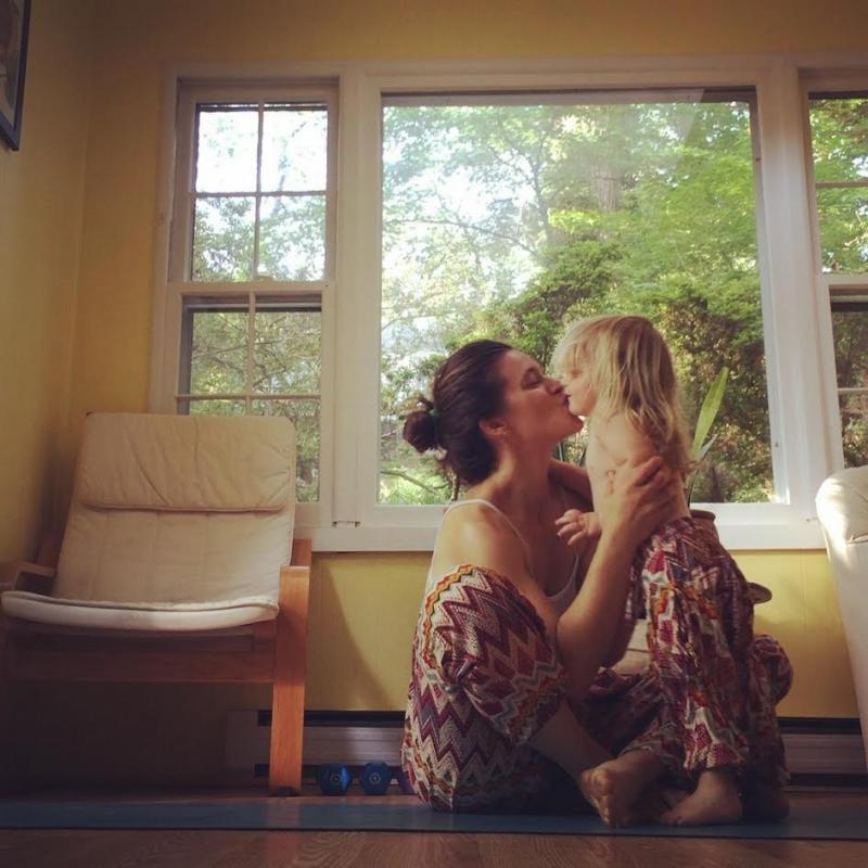 Naomi Gottleib-Miller, who chose to work with a midwife and a doula for health care and childbirth coaching, kisses her daughter, Milly.Photo by Naomi Gottleib-Miller