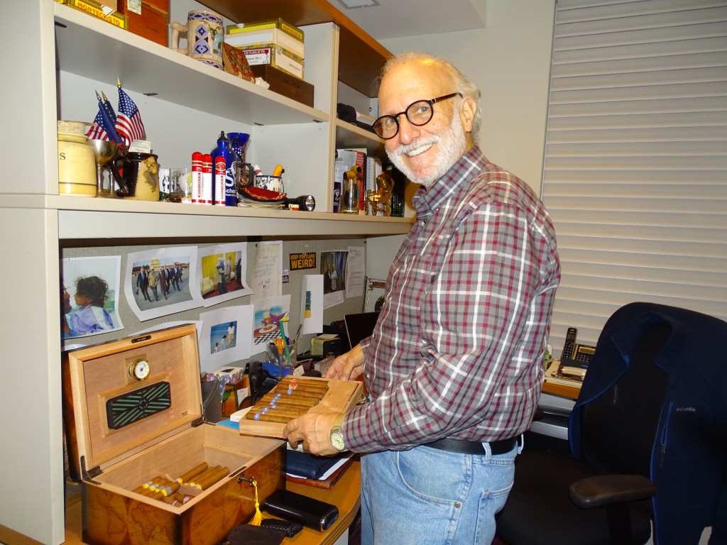 Alan Gross, who was detained in Cuba for five years, shows his Cuban cigars in his home office in Washington. Photo by Suzanne Pollak