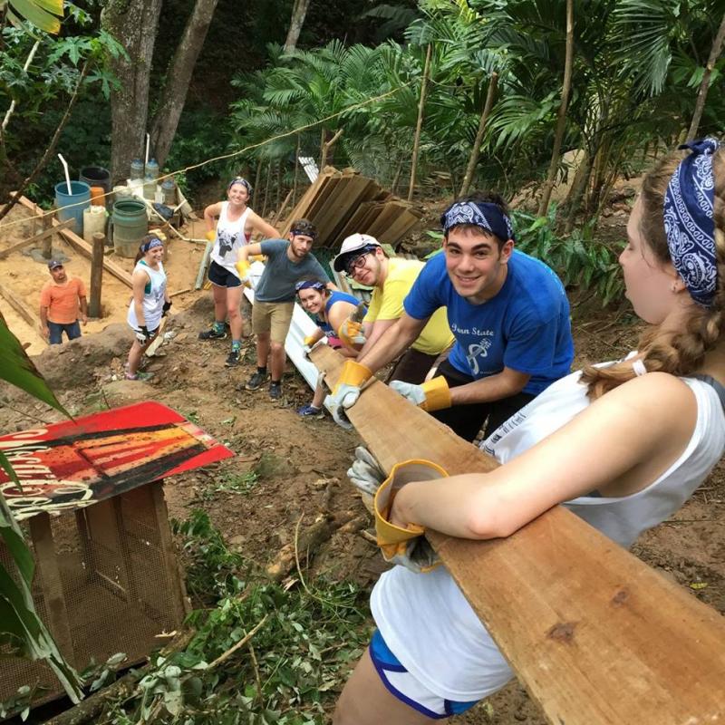 Penn State Hillel students joined motivational speaker Scott Fried for a week long service-learning trip in Roatan, Honduras. Pictured: Robert Ost of Rockville, and Penn State Hillel students carry lumber down the hill to the house foundation on the first day of work. Just weeks before the group arrived in Honduras, a house had collapsed leaving a family of five without a home. Students helped rebuild the home and lift the spirits of the family, who befriended Fried over his years of service to the community.Photo courtesy of Penn State Hillel 