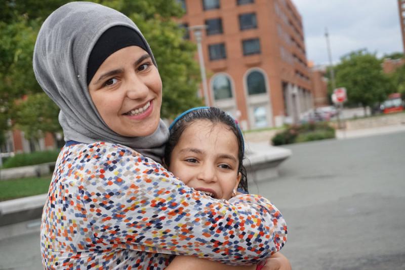 Syrians sisters, resettled with assistance from the International Rescue Committee, share a hug in their adoptive city of Baltimore. Photo Camille Wathne/IRC Camille Wathne/IRC