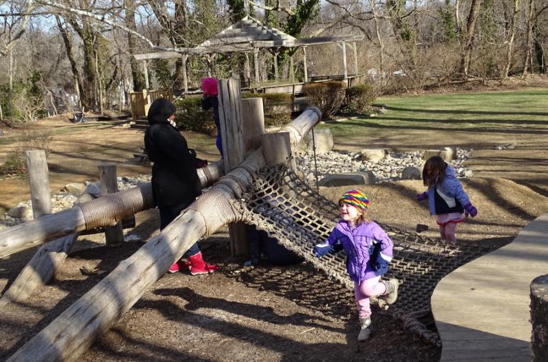 Temple Emanuel of Kensington preschool students play among the trees, rocks and climbing structures to learn about nature. Photo by Suzanne Pollak