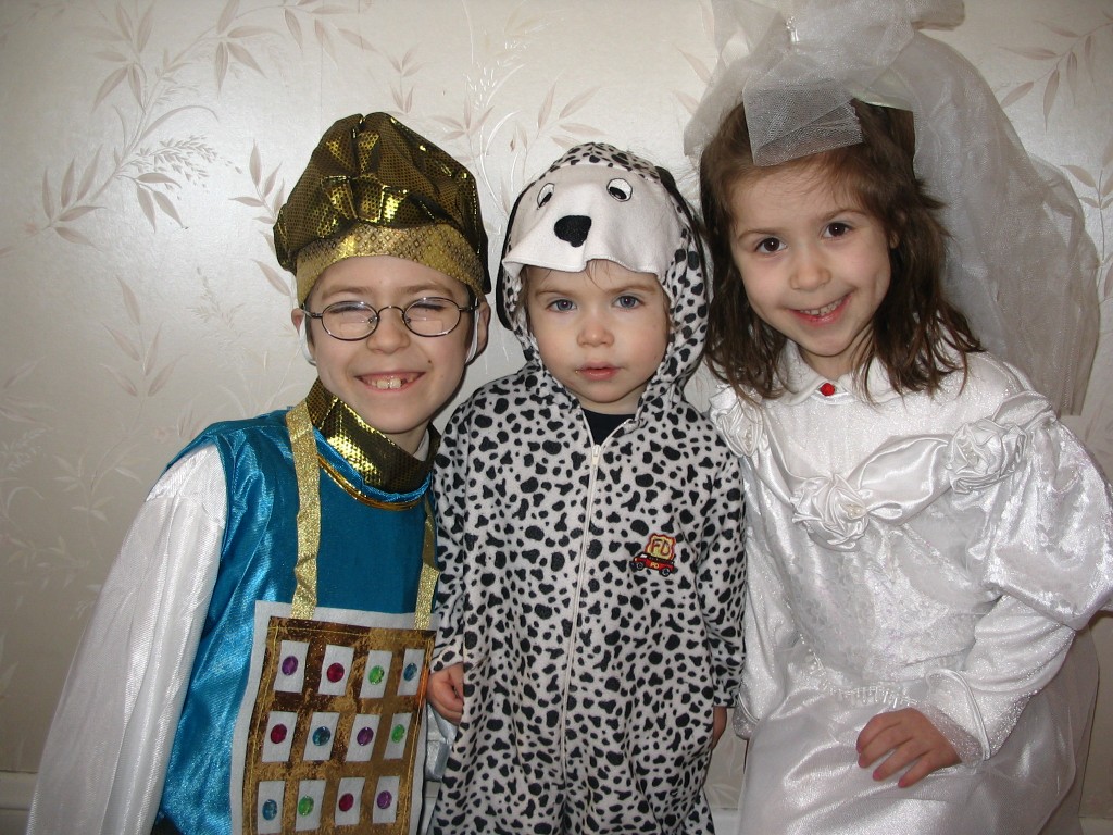 Children who want to dress as a, from left, high priest, Dalmatian or bride, need look no further than Bracha Orlansky’s Purim gemach. Photo provided