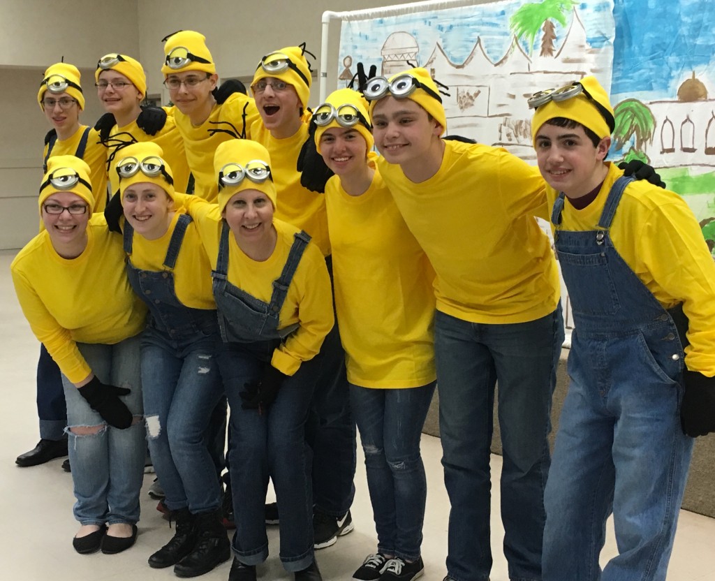Cantor Rochelle Helzner, front row, third from left, of Tikvat Israel Congregation in Rockville assembled a Minyan of Minions for the synagogue’s evening Purim celebration March 24. USY members and the synagogue’s education and youth programming director, Rachel Denrich, front row, far left, helped make the minyan. Also shown are Hannah Smith, front row, second from left, and back row, from left, Jordan Herling, Jacob Mannes, Matthew Kaminow, Joseph Gelula, Sophia Kram, Jacob Schwartz and Micah Shull.Photo by Felicia R. Black