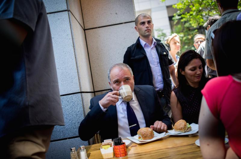 Defense Minister Avigdor Liberman drinking coffee at Sarona Market in Tel Aviv, a day after a deadly attack at the pedestrian mall, June 9. Photo by Miriam Alster/Flash90 via JTA