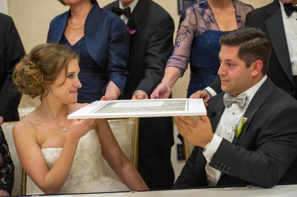 Kirsten and Jonathan Sidell pause after signing their ketubah in October 2015 Photo provided