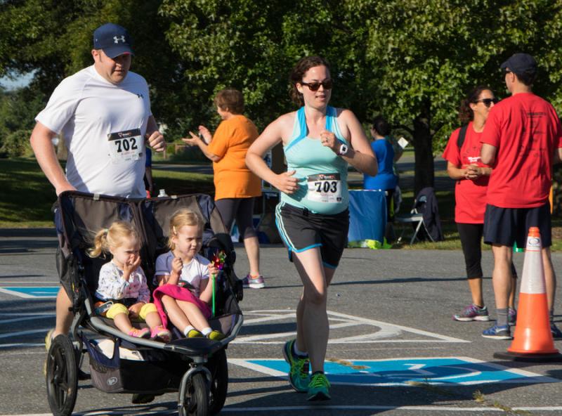 Several parents took up the challenge of running the 5K with their children in tow. Photo by Justin Katz