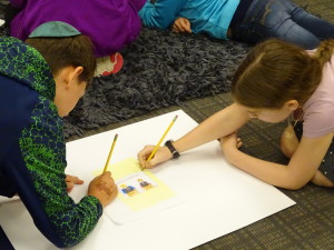 JPDS sixth-graders Isaac Trommer, left, and Adina Siff design their own political cartoon as part of the curriculum that is looking at political messaging. Photos by Daniel Schere