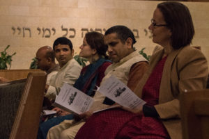 Members of the Krishna Temple await their turn to lead the congregation.