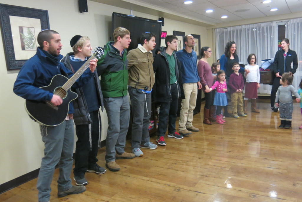 The Berman Academy Parent Teacher Organization and members of Kemp Mill Synagogue entertain the residents of Arcola Health and Rehabilitation Center in Silver Spring on Dec. 20. The Chanukah Musical Celebration included singing and dancing. Photo by Miriam Friedman 