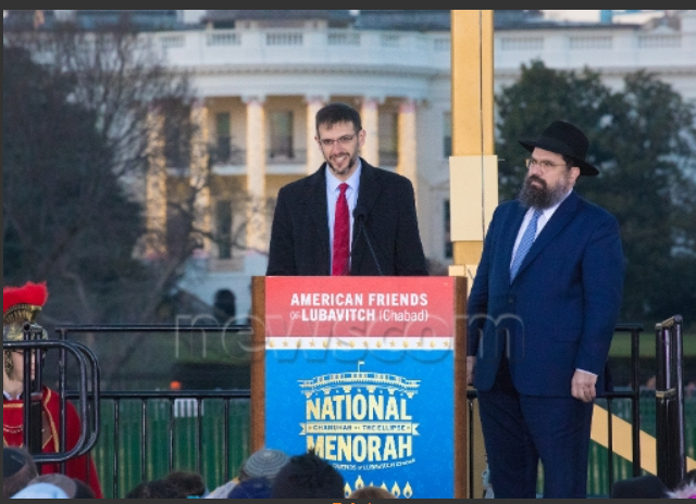 Adam J. Szubin, left, the Treasury’s acting under secretary for terrorism and financial intelligence, finishes his remarks Sunday at the close to 4,000-strong 2016 National Chanukah Menorah lighting ceremony on the Ellipse across from the White House as Rabbi Levi Shemtov, executive vice president of American Friends of Lubavitch (Chabad), prepares to take the podium. In his speech, Shemtov referred to the United Nations as a place of darkness and noted what Israel has recently faced there. Photo by Jeff Malet via Newscom. 