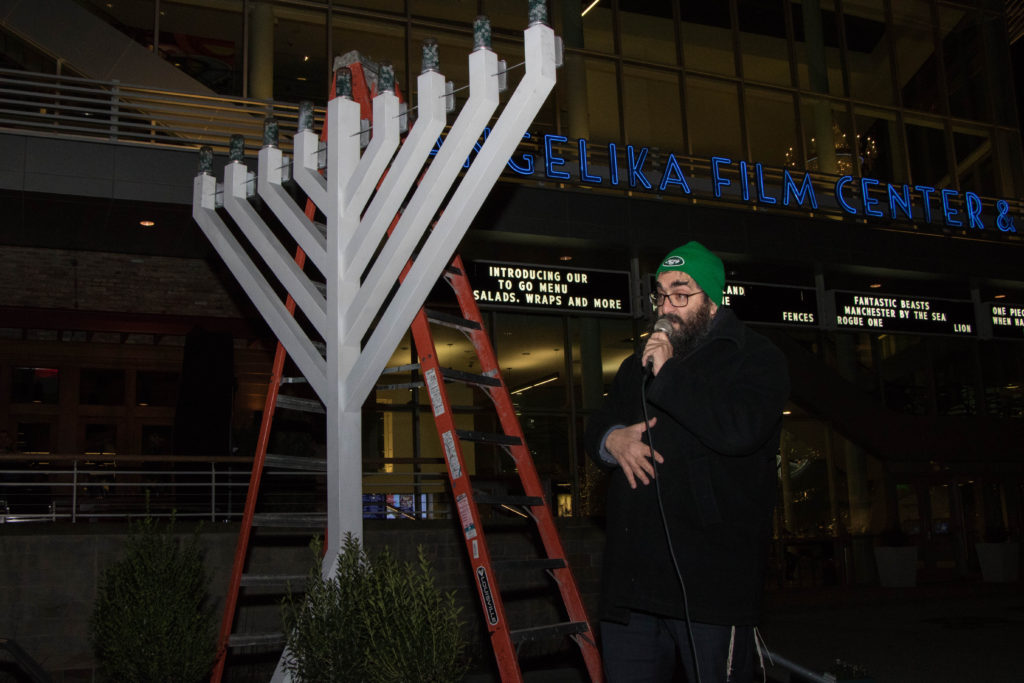 Rabbi Sholom Deitsch leads the Chanukah blessings. Photos by Justin Katz