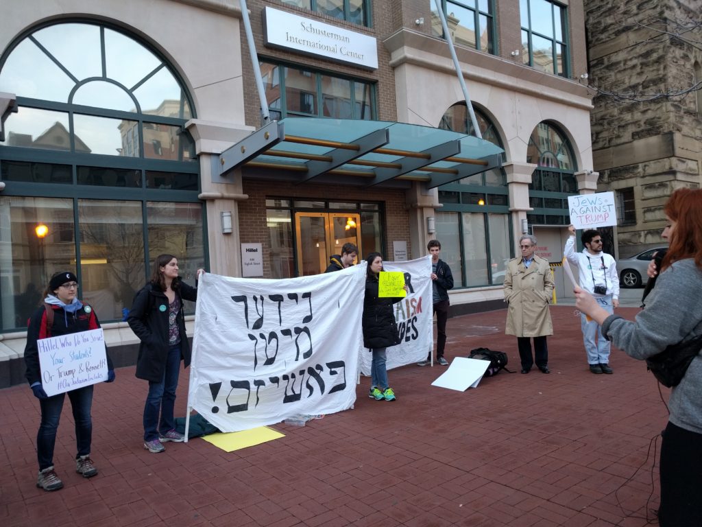 Protestors including Lara Haft, at far right, who made the Yiddish sign that means “Down with facism,” gather outside the offices of Hillel International. Photo by George Altshuler