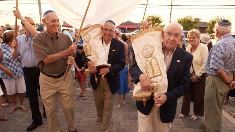 Mickey Radman, right, holds the Torah that served his Latrobe, Pa., congregation for so many years.  Photo courtesy 371 Productions 