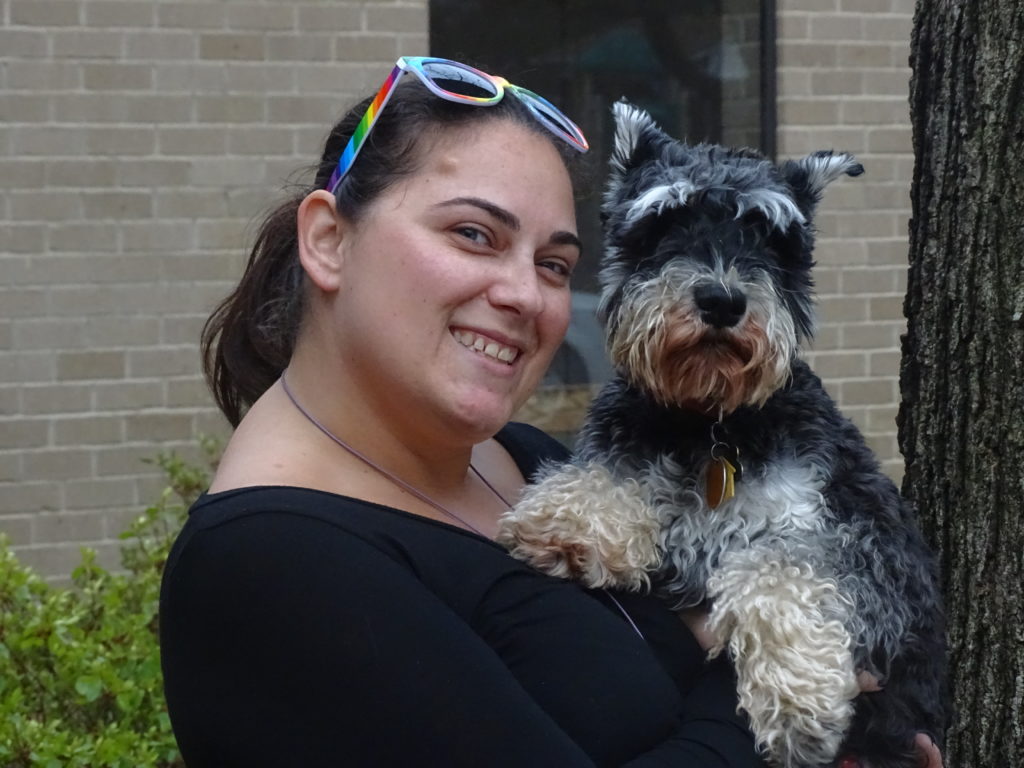 woman holding schnauzer in her arms